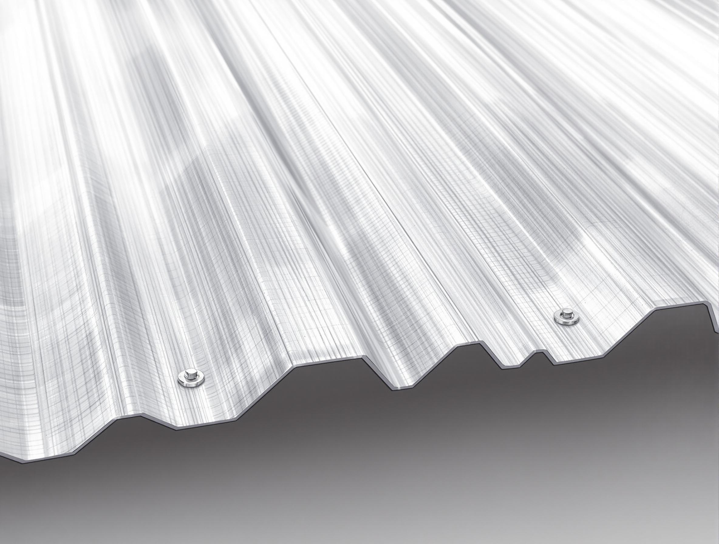 Close-up of exposed-fastener R-panel metal roof showing hex head screws with neoprene washers through trapezoidal ribs, galvalume finish