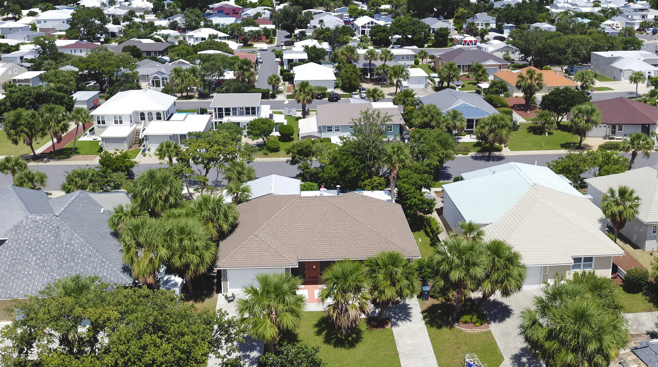 Aerial view of Gulf Coast neighborhood in Gulfport Mississippi showing homes with various metal roof colors and styles